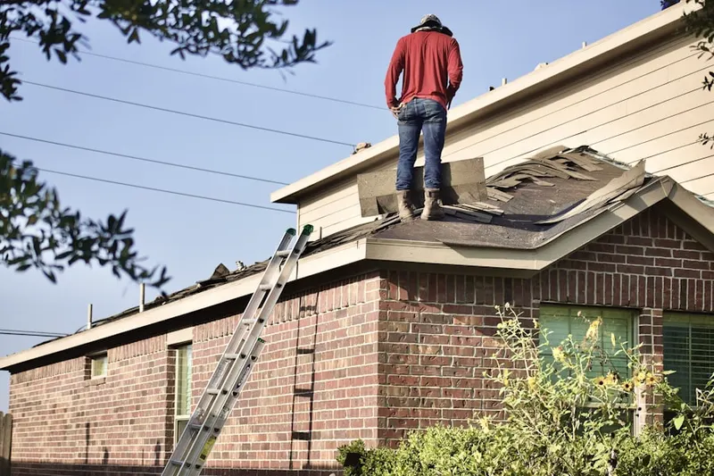 Professional roofer working on a residential roof in Highland Heights